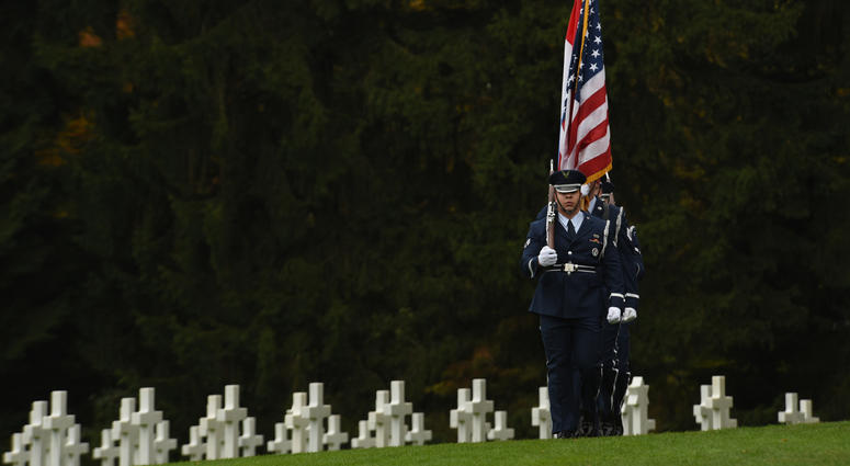 Ceremonial guardsmen from the 52nd Fighter Wing, Spangdahlem Air Base, Germany, march while carrying the Luxembourg and American flags during a Veteran’s Day ceremony at the Luxembourg American Military Cemetery and Memorial in Luxembourg, Nov. 11, 2016. cemetery
