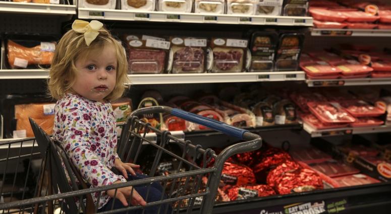 Quinn Prosper, daughter of Jina Prosper, Combat Center patron, attends the reopening of the Combat Center’s Commissary, Oct. 21, 2017. The command and DeCA worked diligently to restore the facility to the standards the patrons expect and deserve.