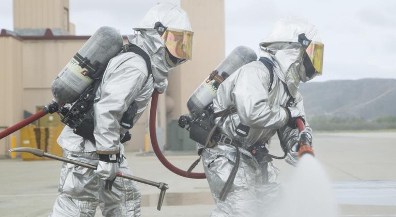 U.S. Marine Corps Lance Cpl. Robert Brewer, 20, an expeditionary firefighting and rescue specialist, puts out a simulated fire using a handline so firefighters can retrieve injured personnel during a routine training exercise on Camp Pendleton, Calif.