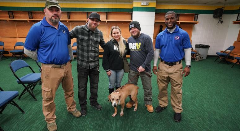 Brantley Gilbert (2nd from Left) is presenting 8 veterans with comfort dogs during his current tour.