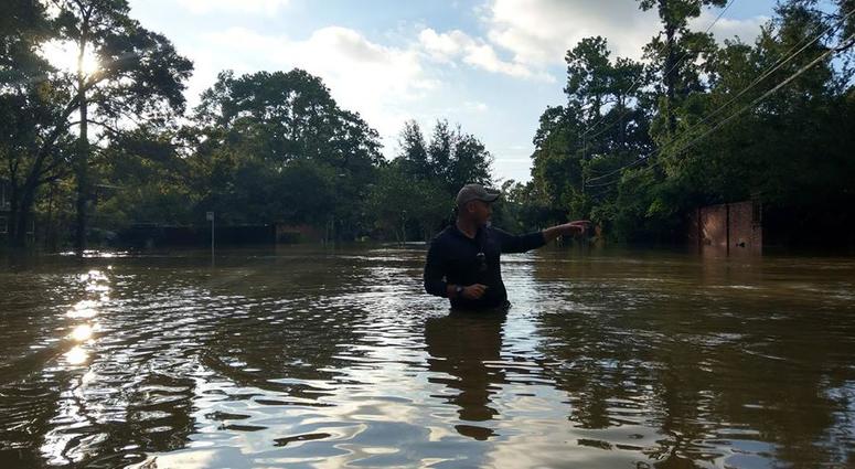 Grunt Style founder Dan Alarik wades through severe flooding in Woodsboro, Texas