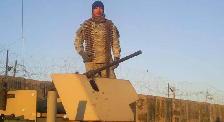 Ivan Lievanos standing on his Humvee next to a .50 cal machine gun.