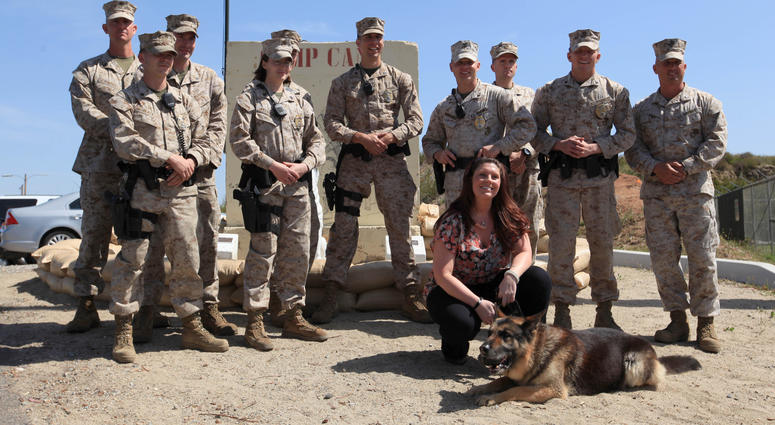 Camp Pendleton dog handlers and Former Cpl. Megan Leavey pose with Military Working Dog Rex during his retirement ceremony and adoption at the base's K-9 unit.