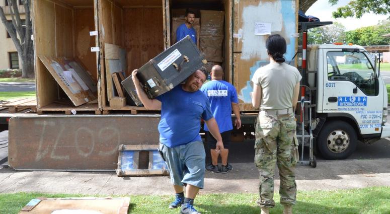 1st Lt. Kathryn Bailey, a Black Hawk pilot with the 2nd Battalion, 25th Aviation Regiment, 25th Combat Aviation Brigade, 25th Infantry Division supervises the delivery and unpacking of her household items May 11 on Wheeler Army Airfield.
