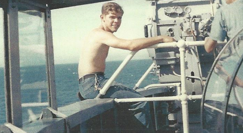 A young Raymond Pierson is seen on the signal bridge soaking up some sun in the Gulf of Tonkin, a few miles off the coast of Vietnam in 1967.
