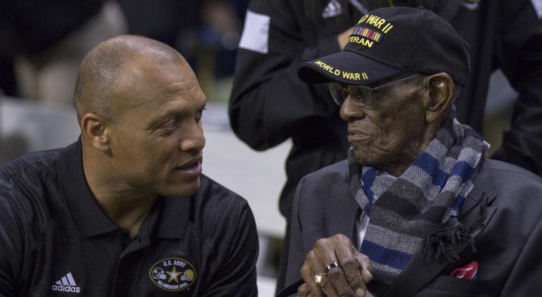 Pro Football Hall of Famer Aeneas Williams shares a moment with 110-year-old former U.S. Army Sgt. Richard Overton, the oldest living World War II veteran.