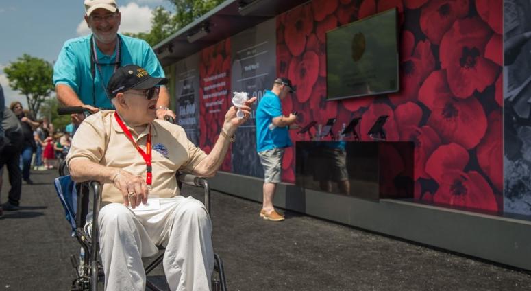 A WWII Veteran observes an exhibit at The Poppy Wall Memorial on 26 May, 2018 in Washington DC. A veteran takes in the Poppy Wall of Honor in 2018