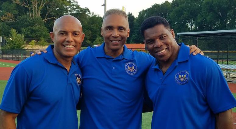 The Hon. Rob Wilkins (center) with MLB hall-of-famer Mariano Rivera (l) and multi-sport superstar Herschel Walker (r) A photo of Air Force veteran Rob Wilkins alongside Yankees legend Mariano Rivera and multi-sport superstar Herschel Walker
