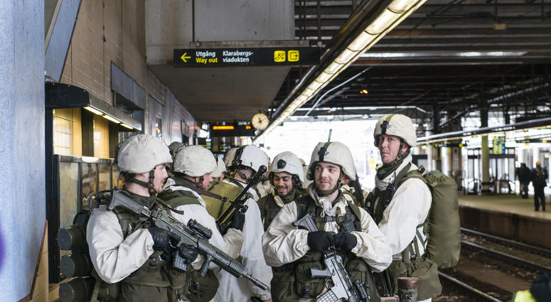 STOCKHOLM, March 8, 2017 (Xinhua) -- A group of Swedish soldiers and officers equipped with combat gear and weapons wait for a train at a railway station during a march through central Stockholm, capital of Sweden, on March 8, 2017.
