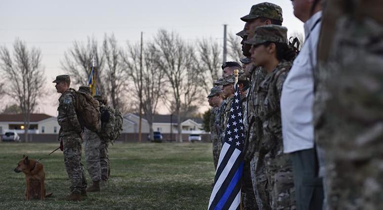 Participants of the 2019 377th Security Forces Squadron Suicide Awareness Ruck March stand in formation at Kirtland Air Force Base, N.M., March 29, 2019. The ruck march was created to support The Brave Badge Initiative Facebook page. 377thSecurityForcesSquadronSuicideAwarenessRuckMarch