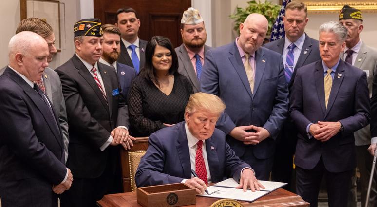 President Donald Trump signs an executive order for veteran suicide prevention at the White House on March 5, 2019. Veterans praise Trump's 2020 budget request