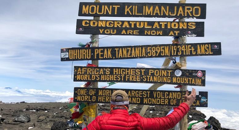 Adam Keys, a triple amputee, at the top of Mount Kilimanjaro--Africa's tallest peak.