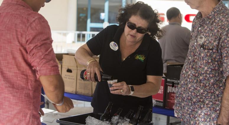 A Marine Corps Community Service employee serves craft beer to an attendee during Oktoberfest at Mokapu Mall, Marine Corps Base Hawaii (MCBH), Oct. 5, 2017.