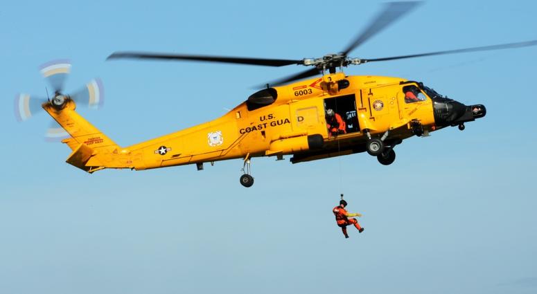 A U.S. Coast Guard MH-60T Jayhawk helicopter gives a rescue demonstration to visiting dignitaries from Vietnam and members of the Oregon National Guard during a tour of the U.S. Coast Guard Station in Warrenton, Oregon, Nov. 15, 2018.