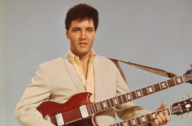 Portrait of American singer and actor Elvis Presley (1935 - 1977) as he holds a twelve string guitar, mid 1950s Portrait of American singer and actor Elvis Presley (1935 - 1977) as he holds a twelve string guitar, mid 1950s