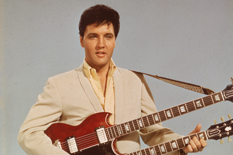 Portrait of American singer and actor Elvis Presley (1935 - 1977) as he holds a twelve string guitar, mid 1950s Portrait of American singer and actor Elvis Presley (1935 - 1977) as he holds a twelve string guitar, mid 1950s
