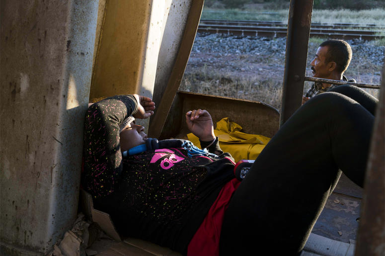 Migrants on La Bestia, or "The Beast" Oct 25, 2016; Sonora, Mexcio; A Honduran women traveling on a freight train, known by migrants as La Bestia, the beast, rests inside a train car south of Caborca, Sonora, about four hours from the border with Arizona. There has been a sharp rise in the nu