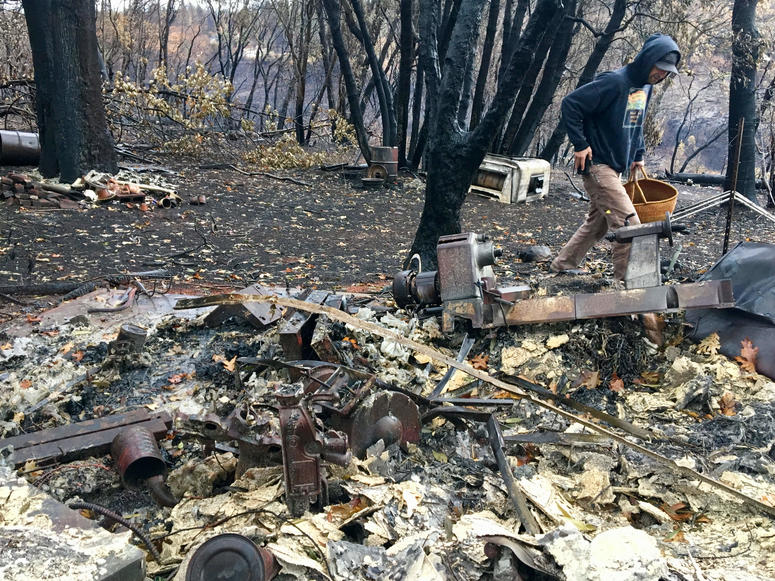 Jessee Ernest roams around the remnants of his parents' home in Paradise after the Camp Fire.