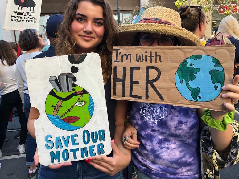 Demonstrators show off their signs during youth day of action on climate change in San Francisco Tens of thousands of Bay Area youth participate in global day of action on climate change