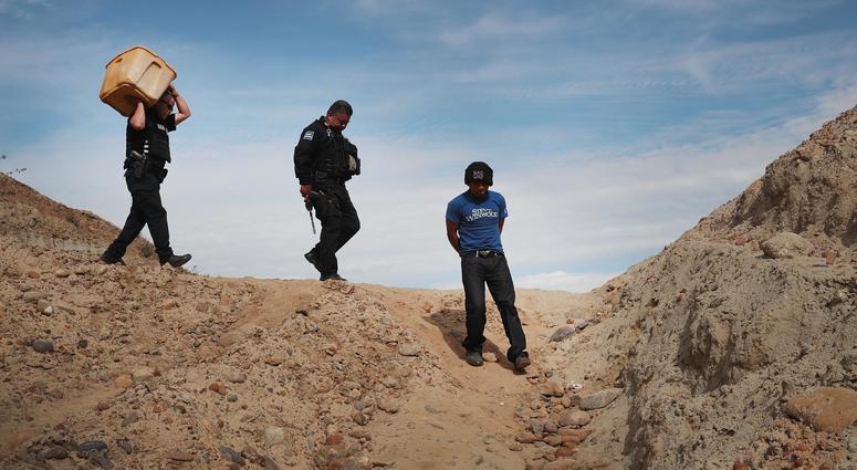 A migrant is taken into custody by Mexican police A migrant is taken into custody by Mexican police