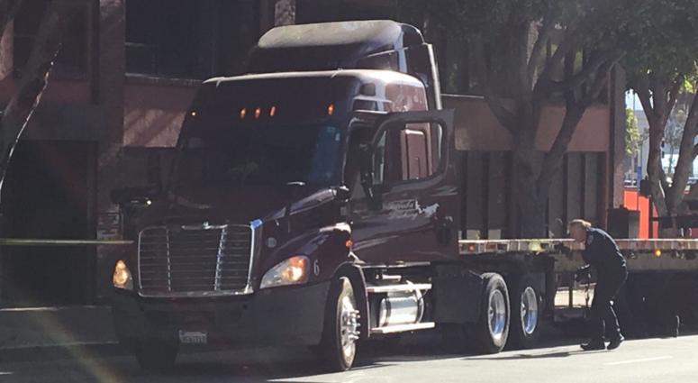 San Francisco police officers examine a truck that was possibly used in a hit an San Francisco police officers examine a truck that was possibly used in a hit and run on Market and Fifth streets on July 18, 2019.