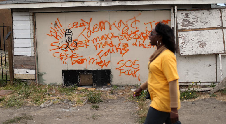 A member of the Richmond, California chapter of the Alliance of Californians for Community Empowerment (ACCE) walks by an abandoned garage during a bus tour of foreclosed and blighted properties on July 13, 2012 in Richmond, California. A member of the Richmond, California chapter of the Alliance of Californians for Community Empowerment (ACCE) walks by an abandoned garage during a bus tour of foreclosed and blighted properties on July 13, 2012 in Richmond, California.