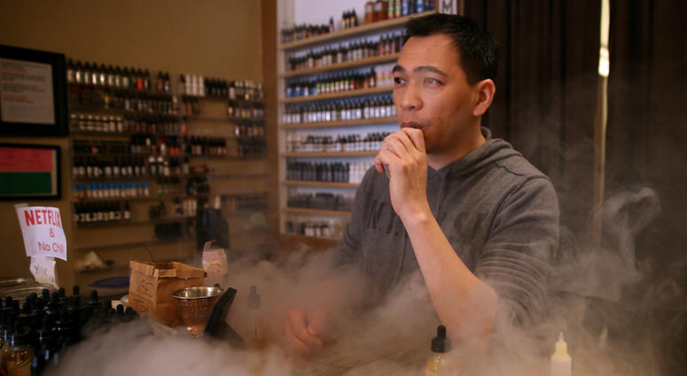 Christopher Chin blows puffs on an e-cigarette as he waits for customers at Gone With the Smoke Vapor Lounge on May 5, 2016 in San Francisco, California. Christopher Chin blows puffs on an e-cigarette as he waits for customers at Gone With the Smoke Vapor Lounge on May 5, 2016 in San Francisco, California.