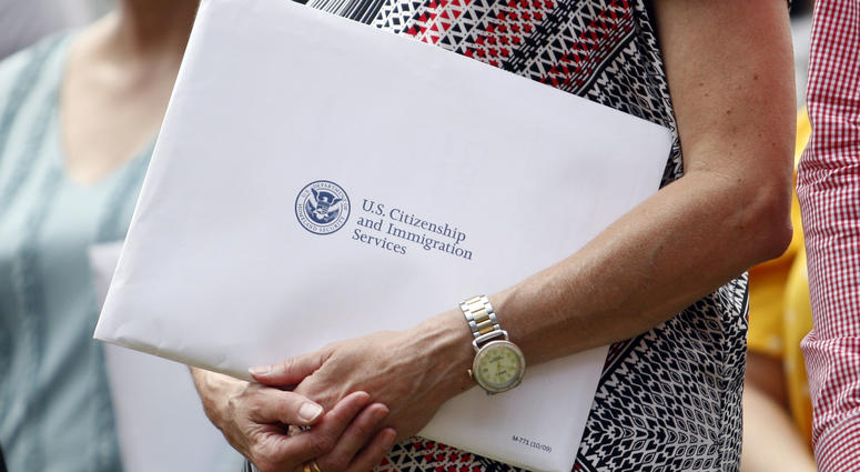 Jun 27, 2019; Detroit, MI, USA; A woman holds her citizenship paperwork before the game between the Detroit Tigers and the Texas Rangers at Comerica Park. Jun 27, 2019; Detroit, MI, USA; A woman holds her citizenship paperwork before the game between the Detroit Tigers and the Texas Rangers at Comerica Park.