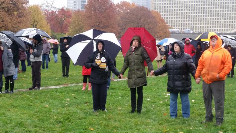 Attendees of the Peace and Unity Rally hold hands at Point State Park