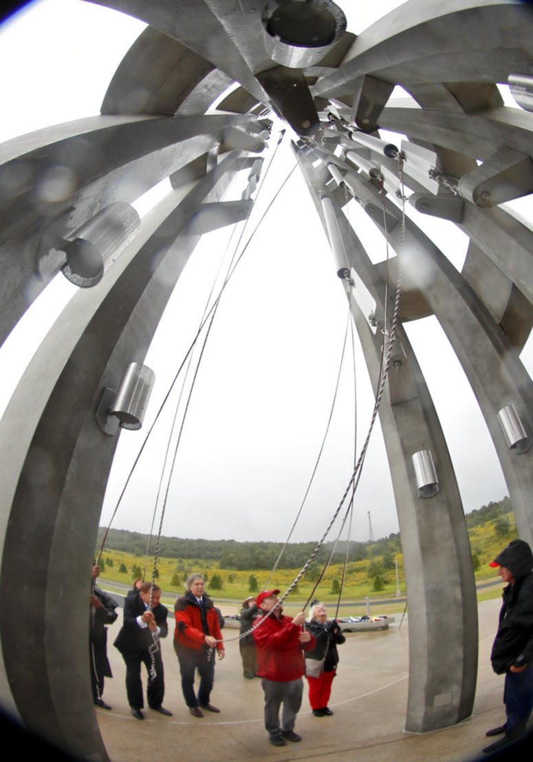 Members of passenger families, friends and volunteer repesentatives pull the ropes to ring the chimes at the dedication of the 93-foot tall Tower of Voices Members of passenger families, friends and volunteer repesentatives pull the ropes to ring the chimes at the dedication of the 93-foot tall Tower of Voices