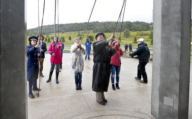 Members of passenger families, friends and volunteer repesentatives pull the ropes to ring the chimes at the dedication of the 93-foot tall Tower of Voices Members of passenger families, friends and volunteer repesentatives pull the ropes to ring the chimes at the dedication of the 93-foot tall Tower of Voices