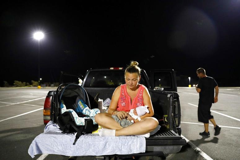 Lorrainda Smith, right, and husband Wilmer Capps prepare to spend the first night out of the hospital with their two-day-old son Luke in a parking lot in Florida. Lorrainda Smith, right, and husband Wilmer Capps prepare to spend the first night out of the hospital with their two-day-old son Luke in a parking lot in Florida.