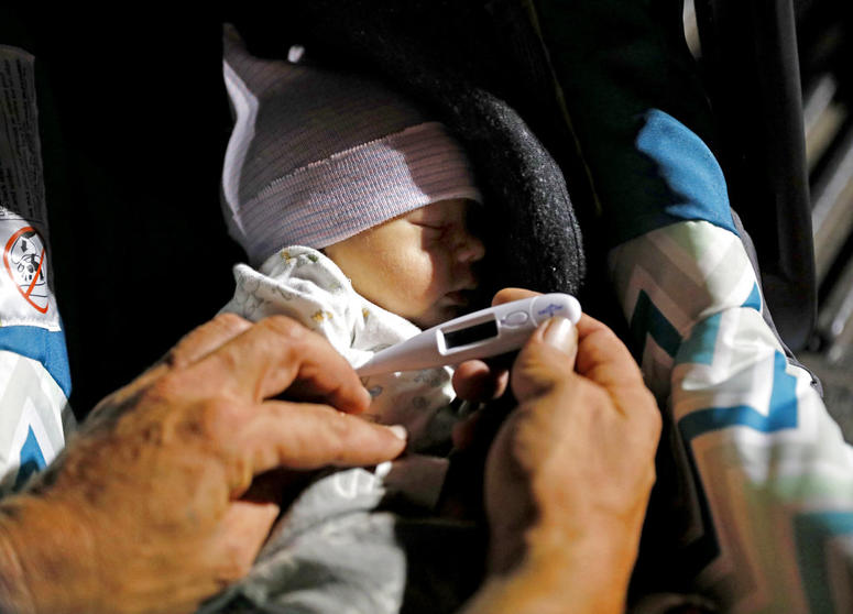 Lorrainda Smith, right, and husband Wilmer Capps prepare to spend the first night out of the hospital with their two-day-old son Luke in a parking lot in Florida. Lorrainda Smith, right, and husband Wilmer Capps prepare to spend the first night out of the hospital with their two-day-old son Luke in a parking lot in Florida.