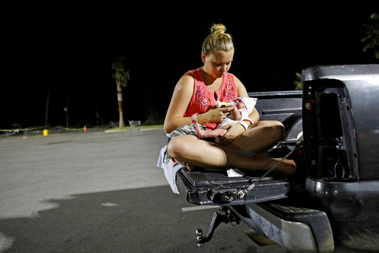 Lorrainda Smith, right, and husband Wilmer Capps prepare to spend the first night out of the hospital with their two-day-old son Luke in a parking lot in Florida. Lorrainda Smith, right, and husband Wilmer Capps prepare to spend the first night out of the hospital with their two-day-old son Luke in a parking lot in Florida.