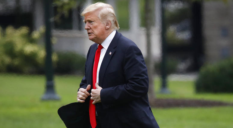 President Donald Trump walks across the South Lawn on return from New York City, Thursday, Sept. 27, 2018, at the White House in Washington. DO NOT USE