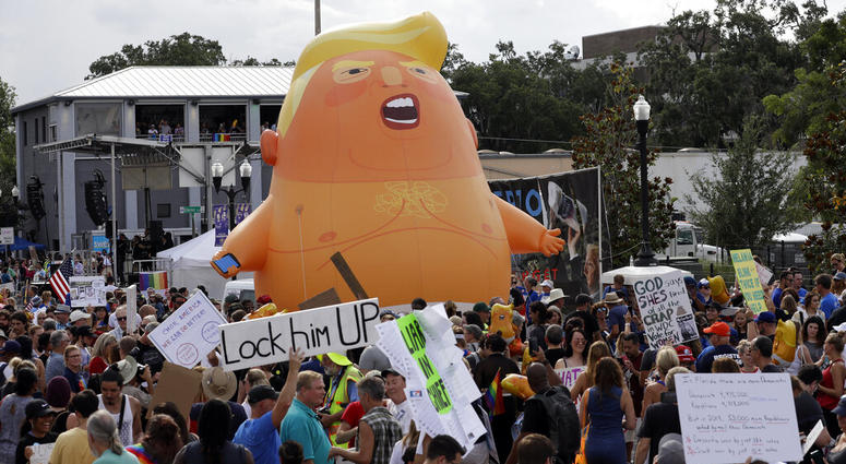 An inflatable Baby Trump balloon towers over protestors during a rally Tuesday, June 18, 2019, in Orlando, Fla AP DO NOT USE