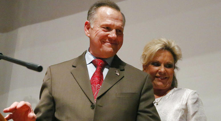 In this Tuesday, Dec. 12, 2017, file photo, Republican Senate candidate Roy Moore walks off the stage with wife Kayla Moore after he spoke to supporters after an election-night watch party