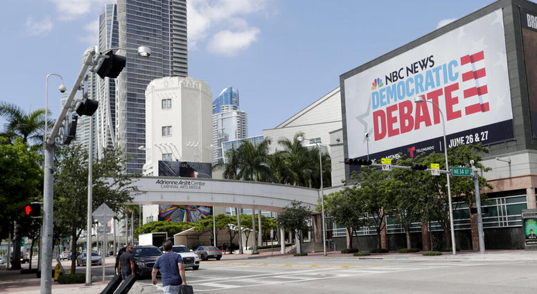 In this June 24, 2019, photo, a billboard advertises the Democratic Presidential Debates across from the Knight Concert Hall at the Adrienne Arsht Center for the Performing Arts of Miami-Dade County, in Miami. AP DO NOT USE