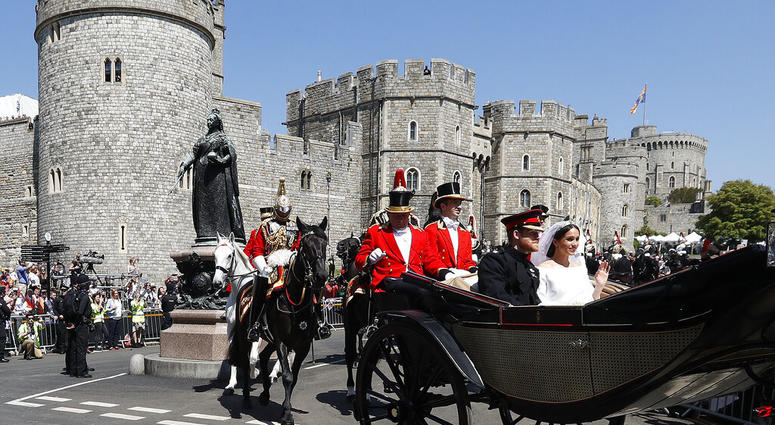 FILE - in this file photo dated Saturday, May 19, 2018, Britain's Prince Harry and Meghan Markle, right, leave Windsor Castle in a carriage after their wedding ceremony at St. George's Chapel in Windsor Castle in Windsor, England. Royal accounts released AP DO NOT USE