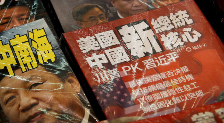 In this Thursday, July 4, 2019, photo, magazines with a front cover featuring Chinese President Xi Jinping against U.S. President Donald Trump, trade war and the South China Sea is placed on sale at a roadside bookstand in Hong Kong. AP DO NO TUSE