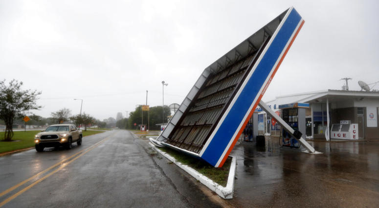 A vehicle passes a toppled gas pump canopy in Berwick, La., following a severe weather assault from Tropical Storm Barry, Saturday, July 13, 2019. A vehicle passes a toppled gas pump canopy in Berwick, La., following a severe weather assault from Tropical Storm Barry, Saturday, July 13, 2019.