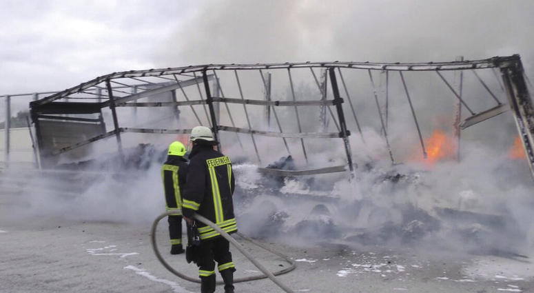 Firefighters attend the scene after a cocoa-laden truck trailer set on fire on the A14 autobahn near Grabow, Germany AP DO NOT USE