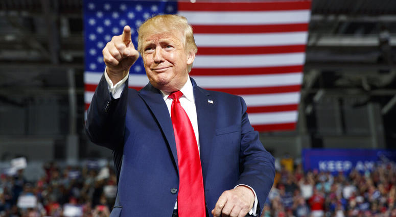 President Donald Trump gestures to the crowd as he arrives to speak at a campaign rally at Williams Arena in Greenville, N.C., Wednesday, July 17, 2019. AP DO NOT USE