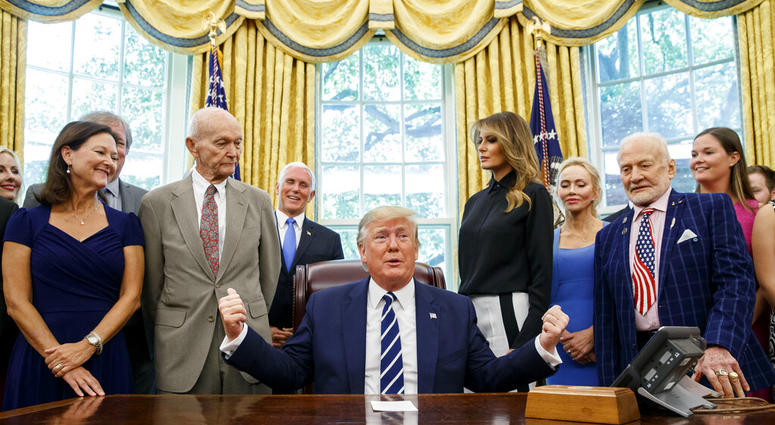 President Donald Trump, accompanied by Apollo 11 astronauts Michael Collins, second from left, and Buzz Aldrin, second from right, with Vice President Mike Pence and first lady Melania Trump, speaks during a photo opportunity commemorating the 50th annive President Donald Trump, accompanied by Apollo 11 astronauts Michael Collins, second from left, and Buzz Aldrin, second from right, with Vice President Mike Pence and first lady Melania Trump, speaks during a photo opportunity commemorating the 50th annive