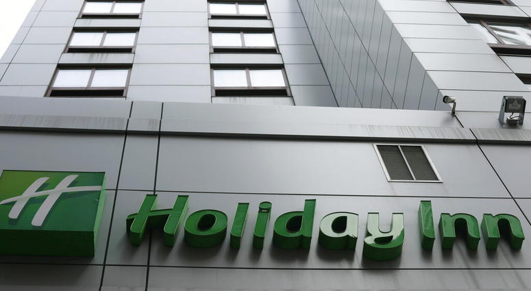 In this file photo dated March 28, 2019, the sign for a Holiday Inn in New York. The fight to save the seas from plastic waste may mean the end for mini bottles of shampoo and other toiletries, after the owner of Holiday Inn and InterContinental Hotels an