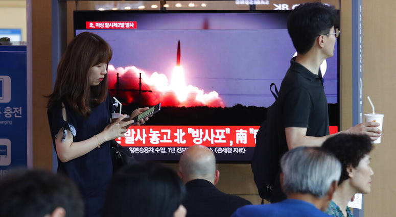 People watch a TV showing a file image of North Korea's missile launch during a news program at the Seoul Railway Station in Seoul, South Korea, Tuesday, Aug. 6, 2019. AP DO NOT USE