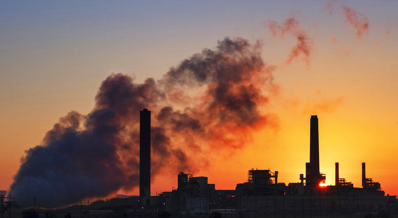 In this July 27, 2018, file photo, the Dave Johnson coal-fired power plant is silhouetted against the morning sun in Glenrock, Wyo.