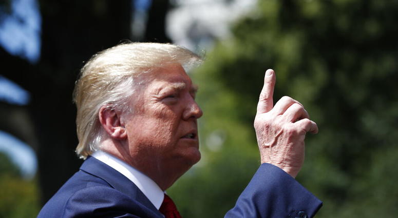 President Donald Trump speaks with reporters before departing on Marine One on the South Lawn of the White House, Wednesday, Aug. 21, 2019, in Washington. Trump is headed to Kentucky.
