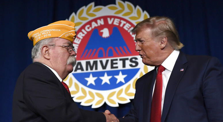 President Donald Trump greets AMVETS national commander Rege Riley at the American Veterans (AMVETS) 75th National Convention in Louisville, Ky., Wednesday, Aug. 21, 2019.