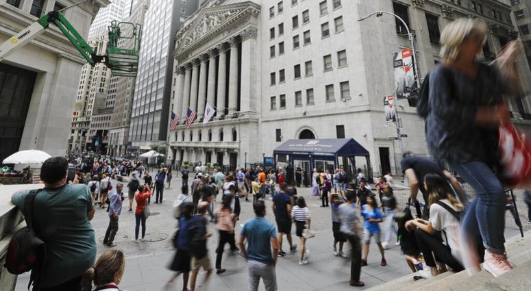 In this Aug. 23, 2019, file photo pedestrians pass the New York Stock Exchange in New York. The U.S. stock market opens at 9:30 a.m. EDT on Friday, Sept. 6. AP DO NOT USE